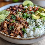 Close-up of a delicious Carnitas Bowl filled with slow-cooked pork, fluffy rice, and creamy avocado.