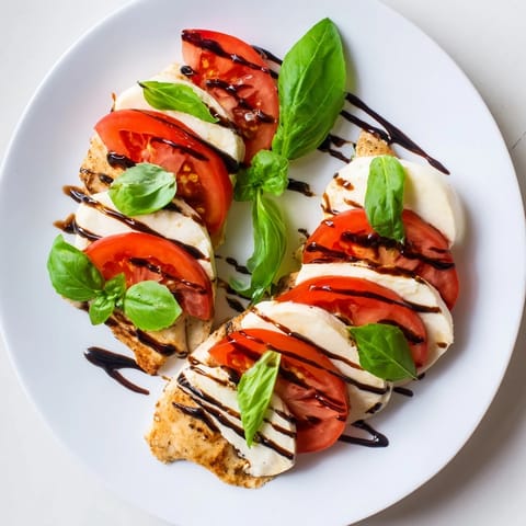 Golden Caprese Chicken Skillet ready to serve, drizzled with balsamic glaze and garnished with torn basil.