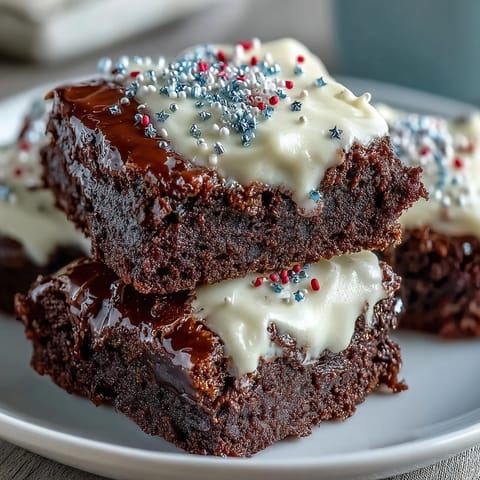 Rich, fudgy brownie bites with creamy frosting and red, white, and blue sprinkles for a festive 4th of July dessert.