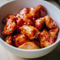 Tender sweet chili chicken glazed in tangy sauce, served over fluffy steamed rice with crisp broccoli florets.