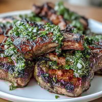 Grilled lamb chops with mint gremolata, tender and juicy, topped with a bright, zesty herb garnish.