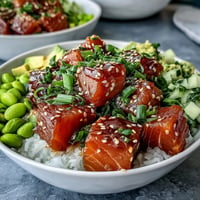 Vibrant salmon poke bowl with creamy avocado and edamame, perfect for lunch.